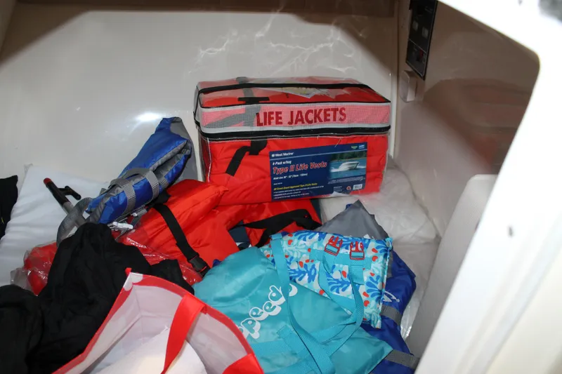 Slide: The Image of Storage compartment with life jackets and gear on a 2018 Chris-Craft Launch 34 boat. - 40