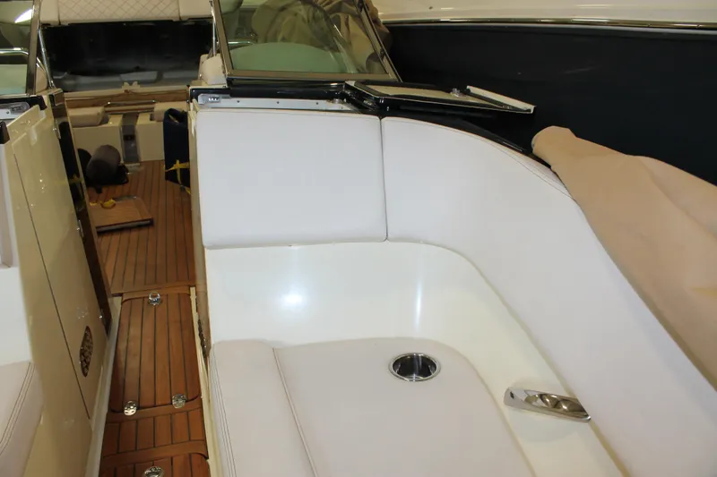 Slide: The Image of 2018 Chris-Craft Launch 34 interior with white seating and wooden flooring. - 42
