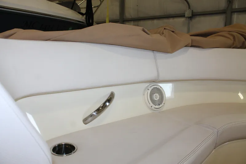 Slide: The Image of 2018 Chris-Craft Launch 34 interior with white seating, speaker, and cup holder. - 43