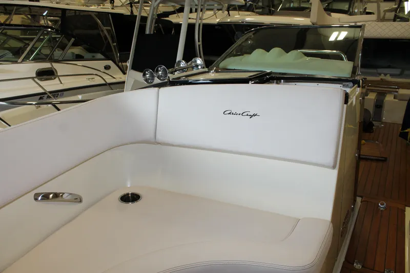 Slide: The Image of 2018 Chris-Craft Launch 34 boat interior with white seating and wooden deck. - 45
