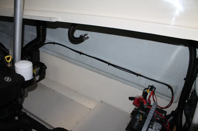 Slide: The Image of Engine compartment of a 2018 Chris-Craft Launch 34 boat, showing battery and wiring. - 54