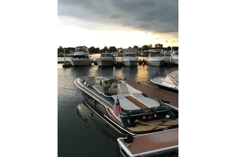Slide: The Image of 2018 Chris-Craft Launch 34 docked at marina during sunset. - 6