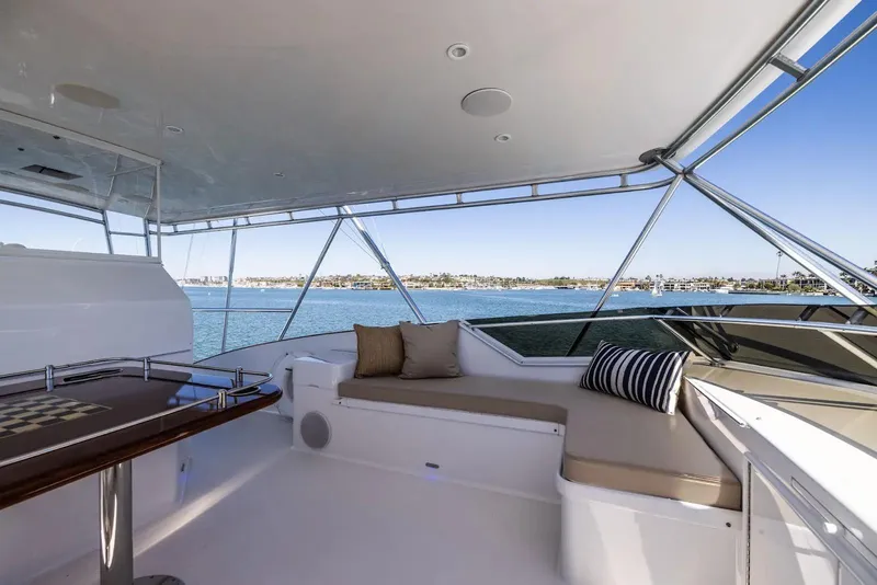 Slide: The Image of Luxurious wooden bar interior on a 1993 Lydia Sportfisher yacht, featuring glassware and elegant decor. - 24