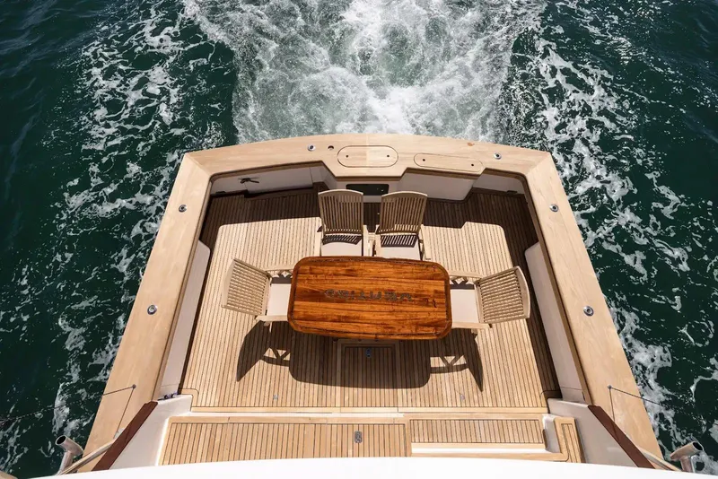 Slide: The Image of Luxurious interior of a 1993 Lydia Sportfisher yacht with elegant wood finishes and marina view. - 25