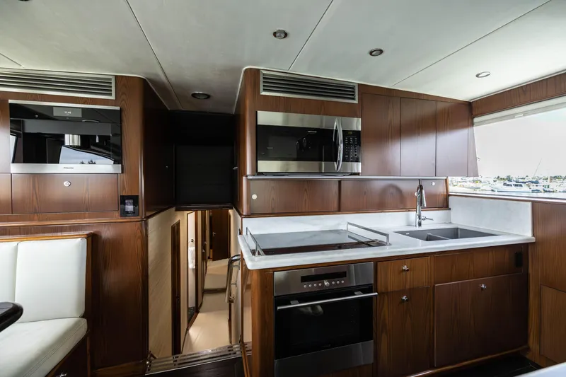 Slide: The Image of Interior cabin of 1993 Lydia Sportfisher yacht with wooden bunk beds and storage. - 33