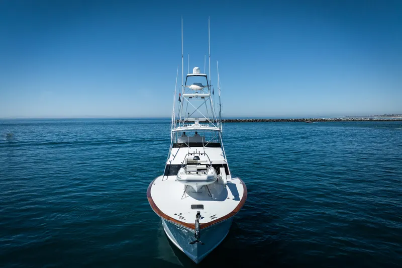 Slide: The Image of A 1993 Lydia Sportfisher yacht docked in a marina under a partly cloudy sky. - 5