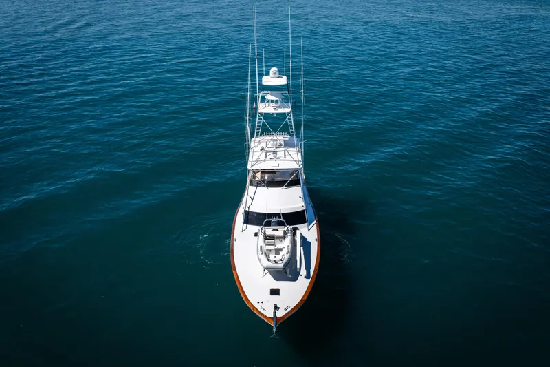 Slide: The Image of 1993 Lydia Sportfisher yacht docked in a marina under a partly cloudy sky. - 6