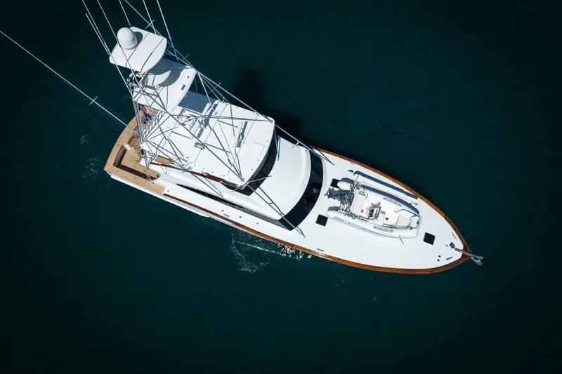 Slide: The Image of 1993 Lydia Sportfisher yacht docked in a marina, clear blue sky, waterfront homes. - 8