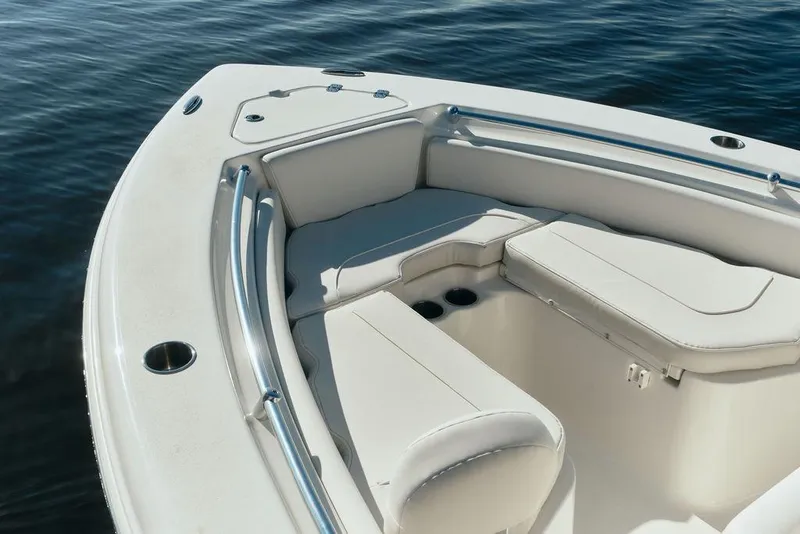 Slide: The Image of 2026 Key West 219 FS boat interior with cushioned seating and cup holders. - 4
