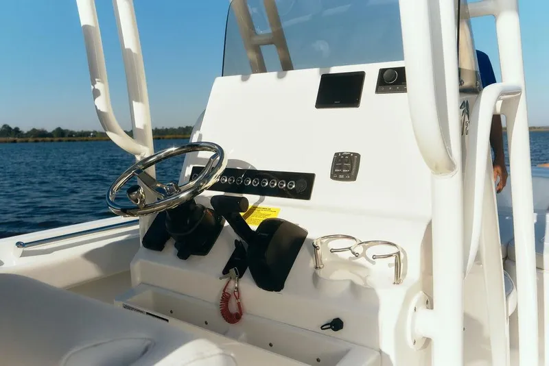 Slide: The Image of Steering console of 2026 Key West 219 FS boat on calm water. - 5