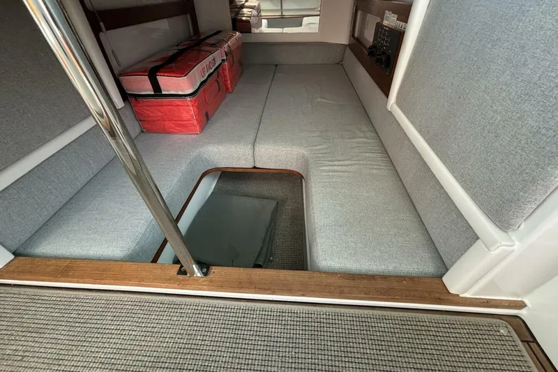 Slide: The Image of Interior cabin of 2019 Axopar 28 Cabin boat with gray seating and storage. - 14