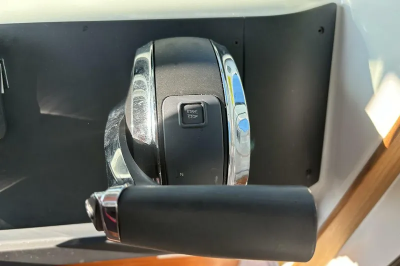 Slide: The Image of Throttle control lever on a 2019 Axopar 28 Cabin boat dashboard. - 23