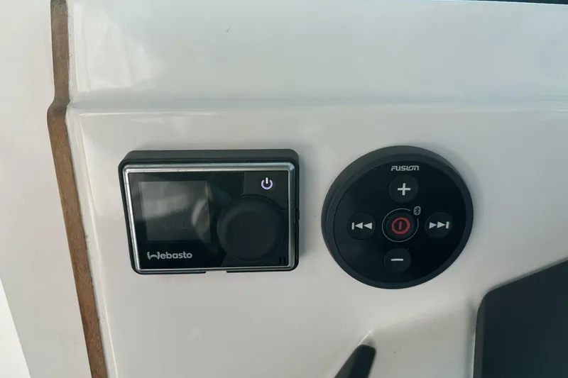 Slide: The Image of Webasto and Fusion controls on 2019 Axopar 28 Cabin boat dashboard. - 25