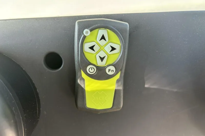 Slide: The Image of Control panel on 2019 Axopar 28 Cabin boat with directional buttons and power switch. - 26