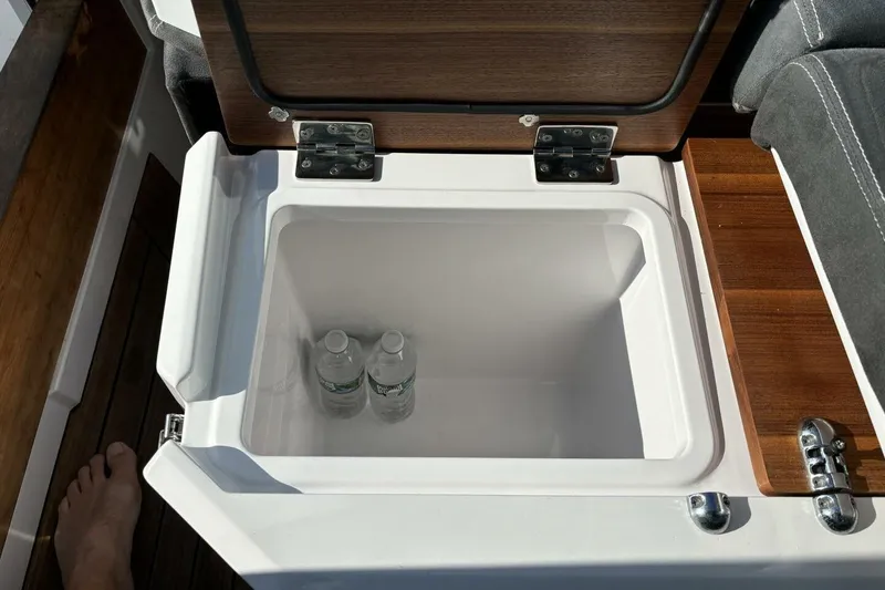 Slide: The Image of Open cooler with water bottles inside on 2019 Axopar 28 Cabin boat. - 27