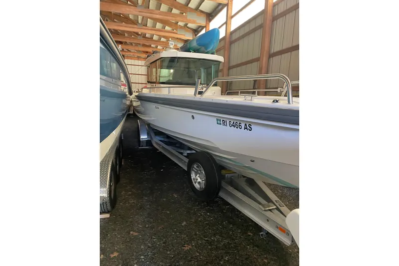 Slide: The Image of 2019 Axopar 28 Cabin boat on trailer in storage facility. - 30