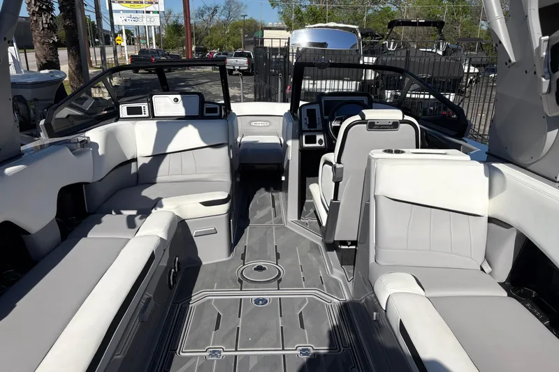Slide: The Image of Interior of a 2021 Supra SE 550 boat with modern seating and dashboard. - 13