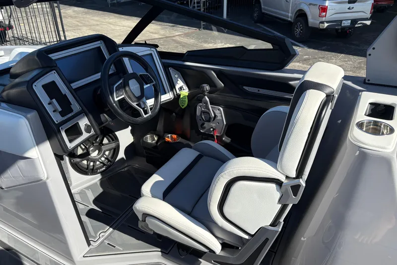 Slide: The Image of 2021 Supra SE 550 boat cockpit with modern steering and controls. - 14