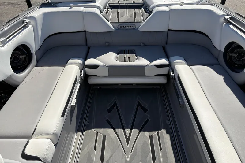 Slide: The Image of Interior of a 2021 Supra SE 550 boat with spacious seating and modern design. - 16