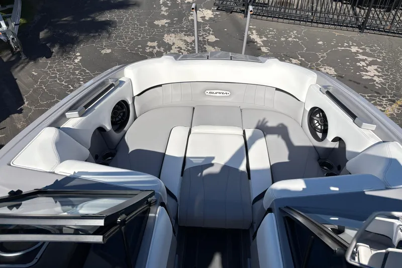 Slide: The Image of 2021 Supra SE 550 boat interior with gray seating and built-in speakers. - 18