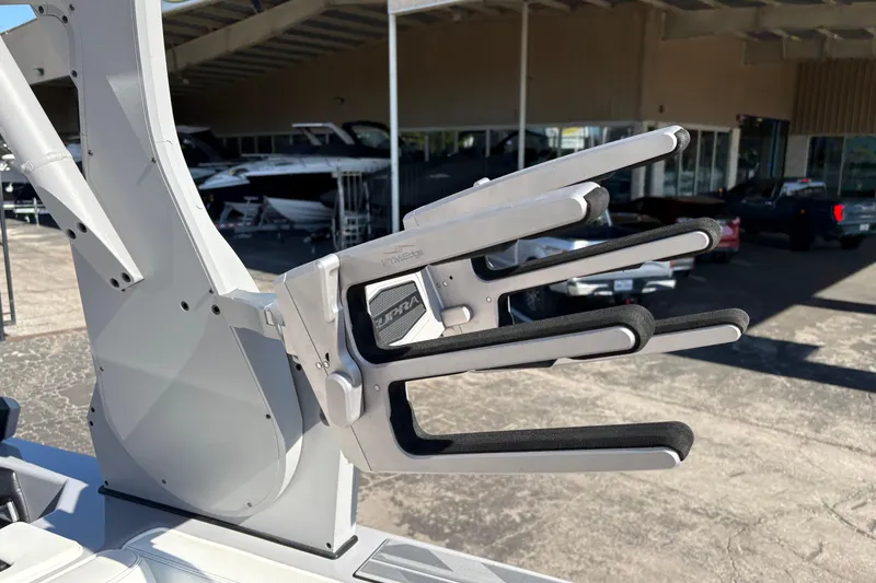 Slide: The Image of 2021 Supra SE 550 boat rack with padded holders in a marina setting. - 21