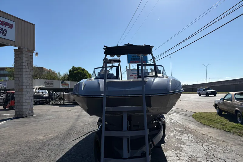 Slide: The Image of 2021 Supra SE 550 boat displayed outdoors at a dealership. - 3