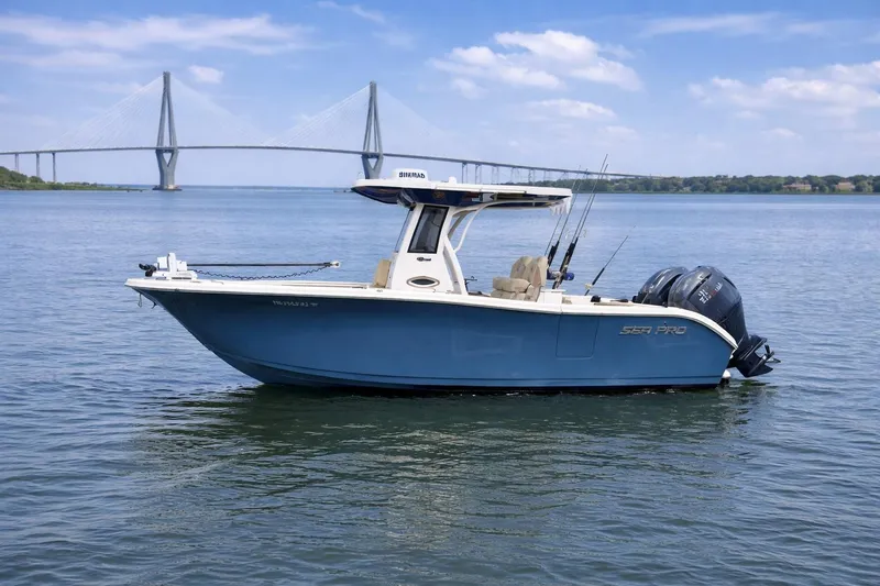 The Image of 2024 Sea Pro 262 DLX boat on water with bridge in background. - 1