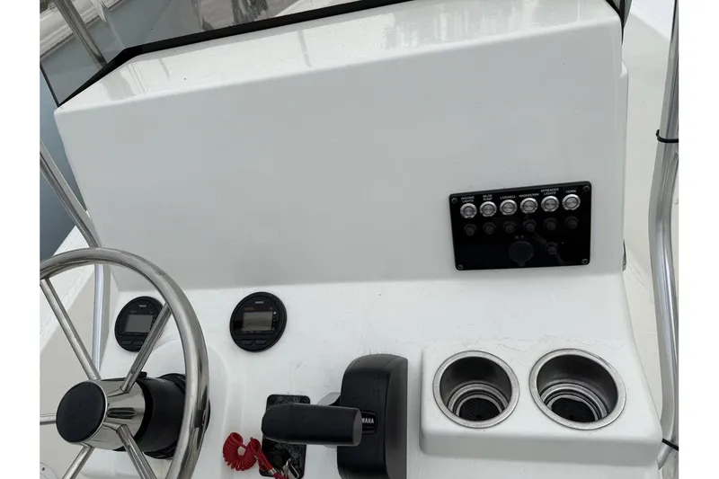 Slide: The Image of 2026 May-Craft 182 boat console with steering wheel, controls, and cup holders. - 4