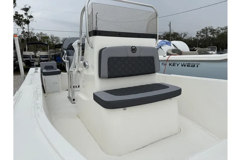 Slide: The Image of 2026 May-Craft 182 boat interior with seating and console, parked outdoors. - 7