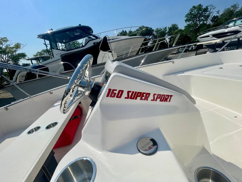 Slide: The Image of Close-up of a Boston Whaler 160 Super Sport helm with a shiny steering wheel. - 7