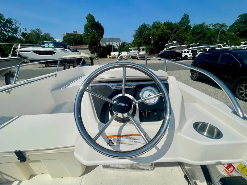 Slide: The Image of The image shows the helm of a 2026 Boston Whaler 160 Super Sport boat. - 6