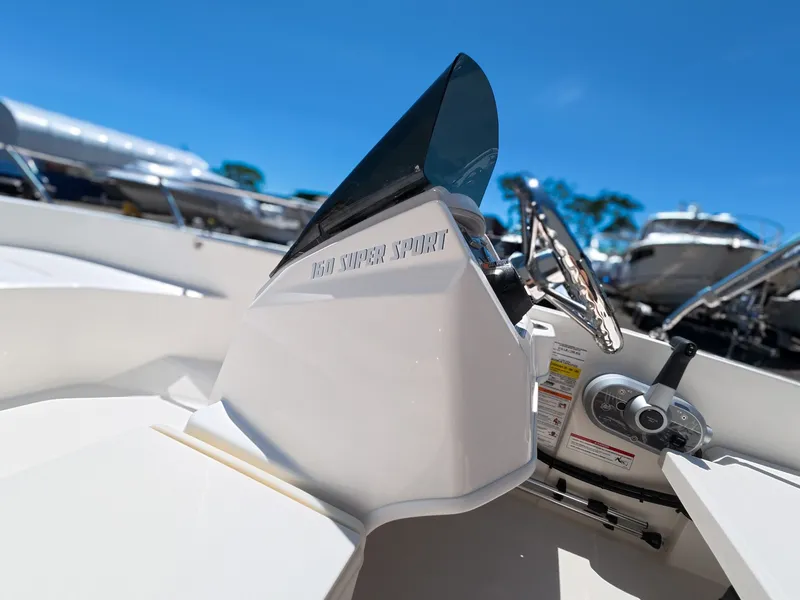 Slide: The Image of Boston Whaler 160 Super Sport 2026 docked under sunny skies. - 14
