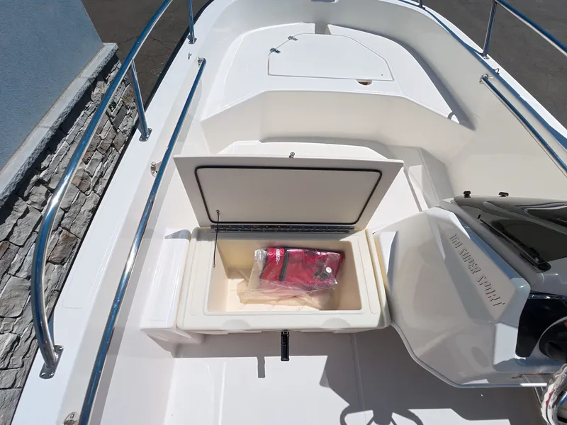 Slide: The Image of Boston Whaler 160 Super Sport 2026 with open storage compartment. - 16