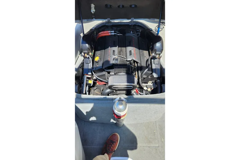 Slide: The Image of Engine compartment of a 2000 MasterCraft Prostar 205 boat, with visible components. - 10