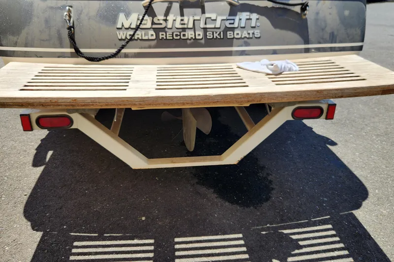 Slide: The Image of Rear view of a 2000 MasterCraft Prostar 205 ski boat with wooden swim platform. - 11