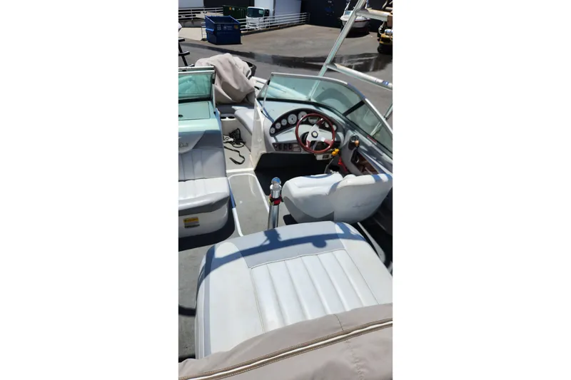 Slide: The Image of Interior of a 2000 MasterCraft Prostar 205 boat with white seating and dashboard. - 7