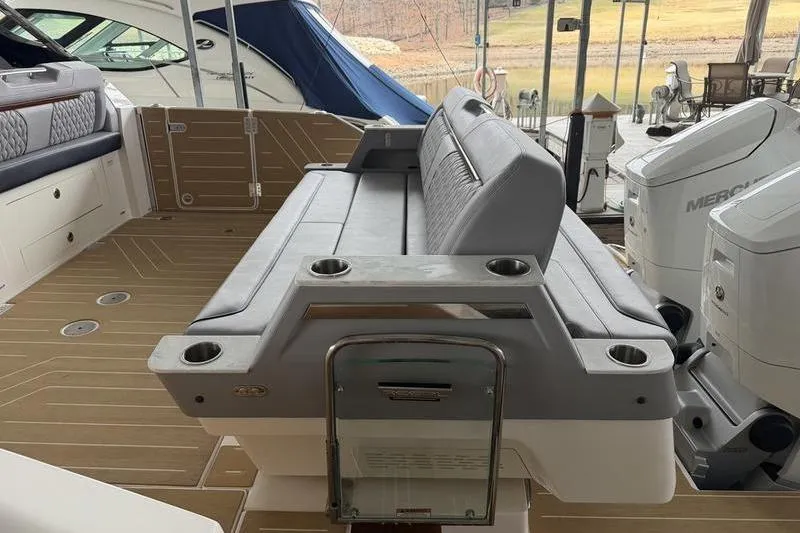 Slide: The Image of Sleek 2025 Regal LX43 boat interior with cushioned seating and modern design. - 14