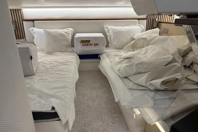 Slide: The Image of Interior cabin of 2025 Regal LX43 yacht with beds and life jackets. - 17