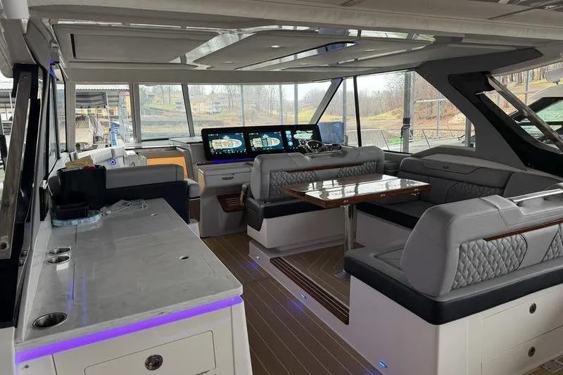Slide: The Image of Luxurious interior of 2025 Regal LX43 yacht with modern seating and navigation displays. - 19