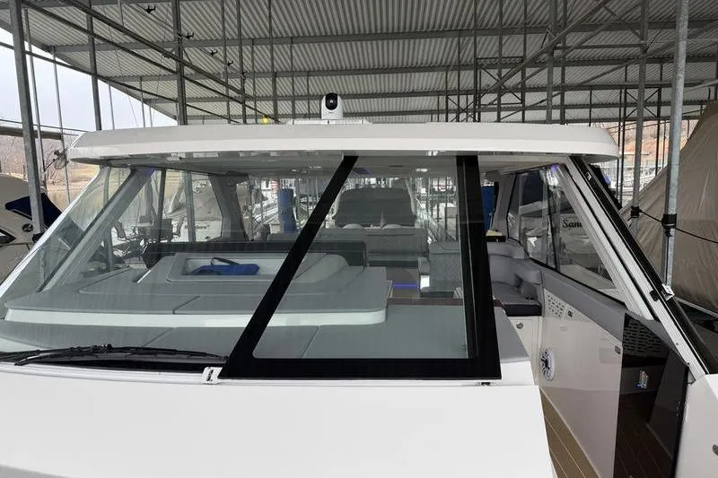 Slide: The Image of 2025 Regal LX43 boat in marina, showcasing sleek design and spacious interior. - 22