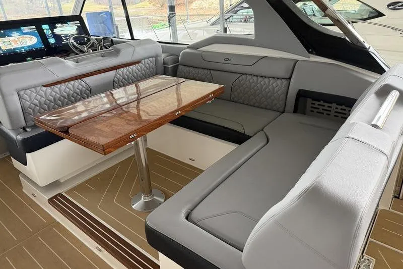 Slide: The Image of Luxurious interior of 2025 Regal LX43 yacht with elegant seating and wooden table. - 28