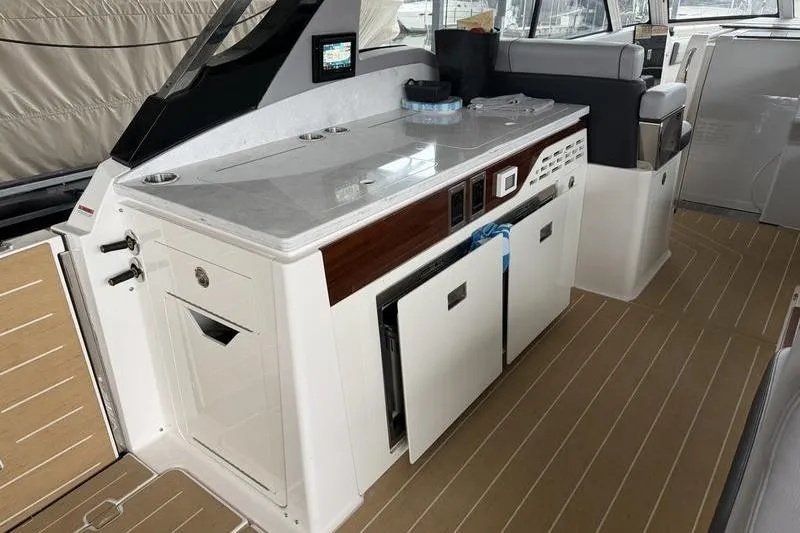 Slide: The Image of Luxurious interior of 2025 Regal LX43 yacht with modern kitchenette and seating area. - 29