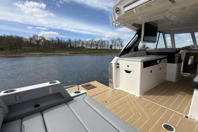 Slide: The Image of Luxurious 2025 Regal LX43 boat interior with scenic lake view. - 32