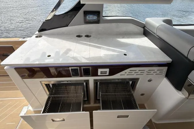 Slide: The Image of Luxury yacht kitchen area on 2025 Regal LX43 with open storage drawers. - 37