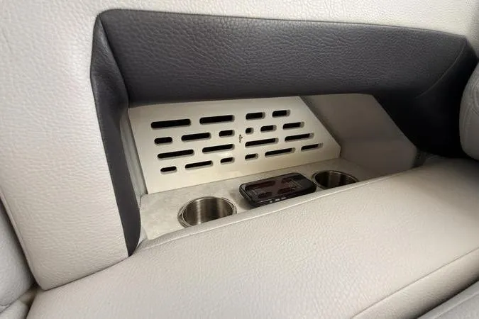 Slide: The Image of Interior of 2025 Regal LX43 featuring cup holders and ventilation panel. - 38