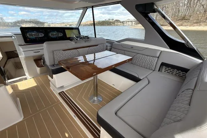 Slide: The Image of Luxurious 2025 Regal LX43 yacht interior with elegant seating and polished wood table. - 42