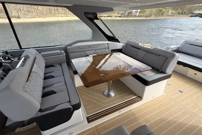 Slide: The Image of Luxurious interior of 2025 Regal LX43 yacht with elegant seating and wooden table. - 43