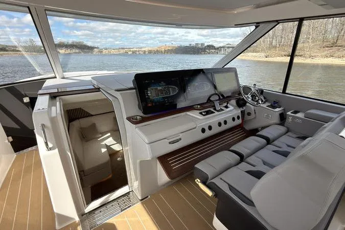 Slide: The Image of Luxurious 2025 Regal LX43 yacht interior with modern navigation system and plush seating. - 46