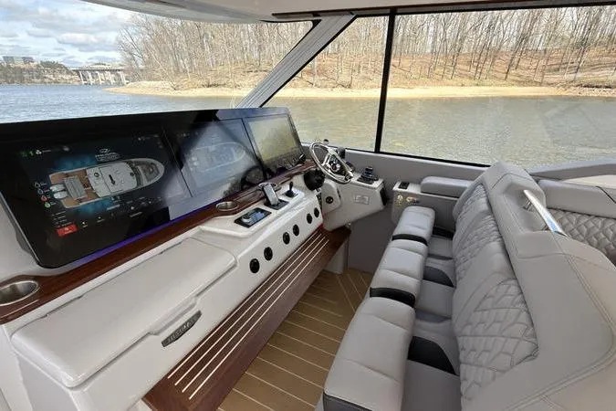 Slide: The Image of Luxurious 2025 Regal LX43 yacht interior with advanced navigation screens and plush seating. - 48