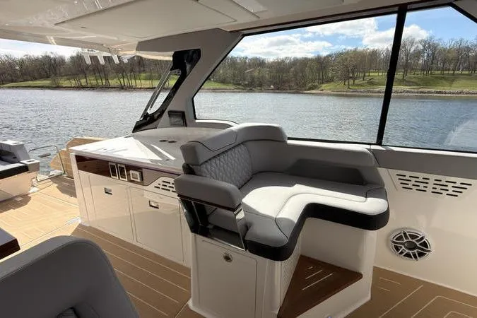 Slide: The Image of Luxurious interior of 2025 Regal LX43 yacht with plush seating and scenic water view. - 50